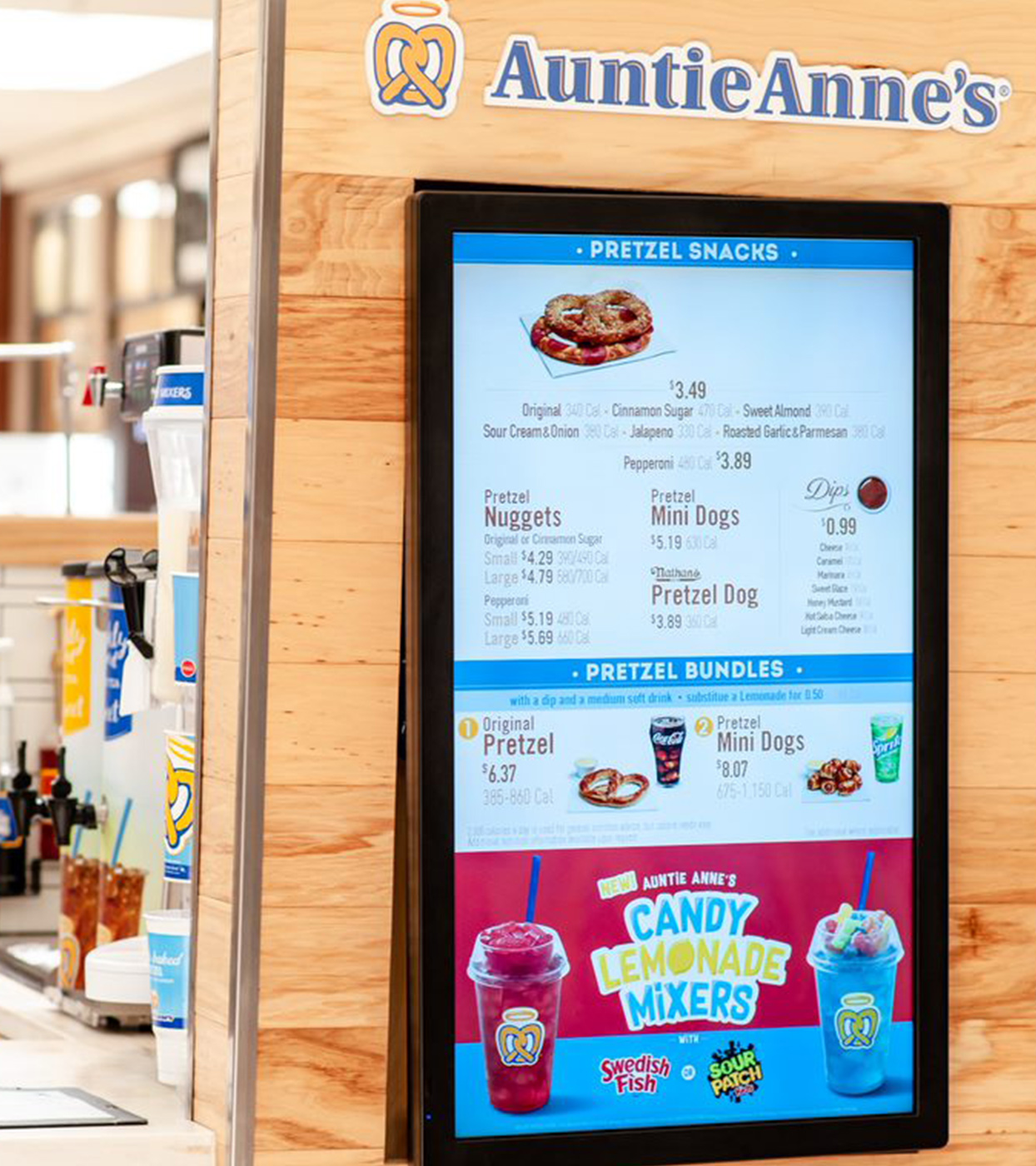A vertically oriented Auntie Anne's digital menu board against a shiplap background.							